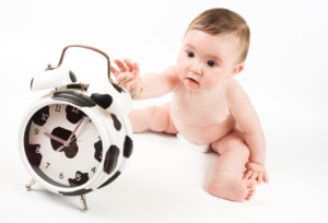 Baby with cow clock.