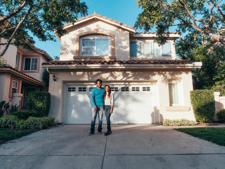 couple standing in front of their house