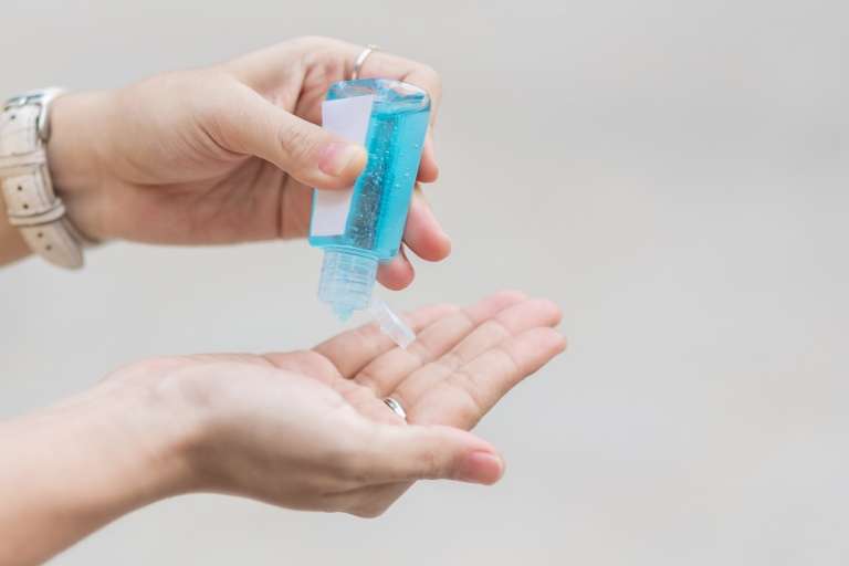 using hand sanitizer, your own